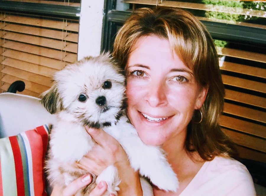 A woman with a fluffy Shih Tzu puppy